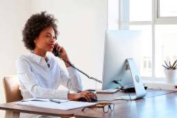 Office staff using VoIP phone technology for their VoIP phone system for business in Canada