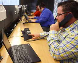 Man using office phone with ethernet cable plugged into back after reboot